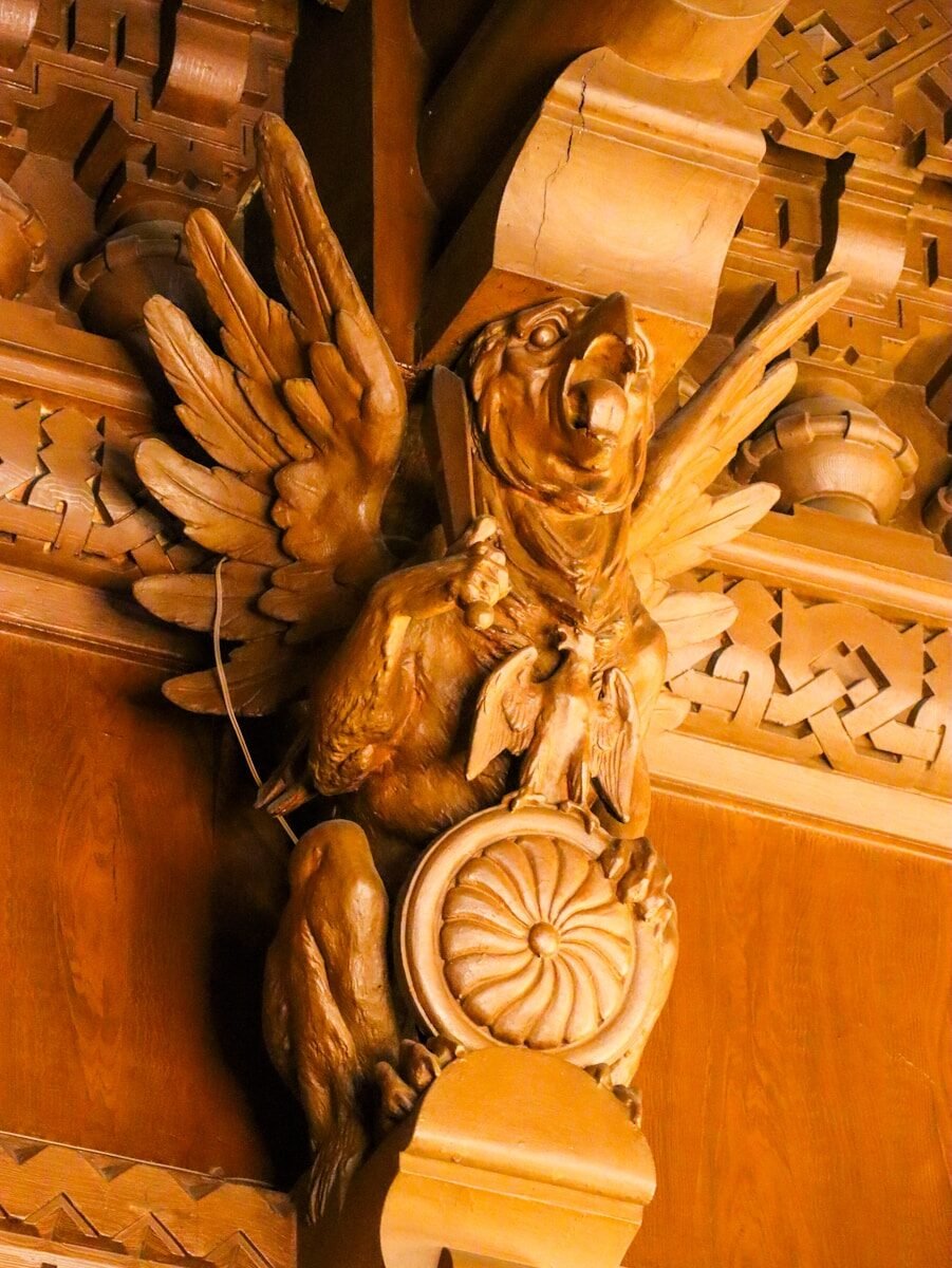 A carved wooden sculpture of a winged creature.