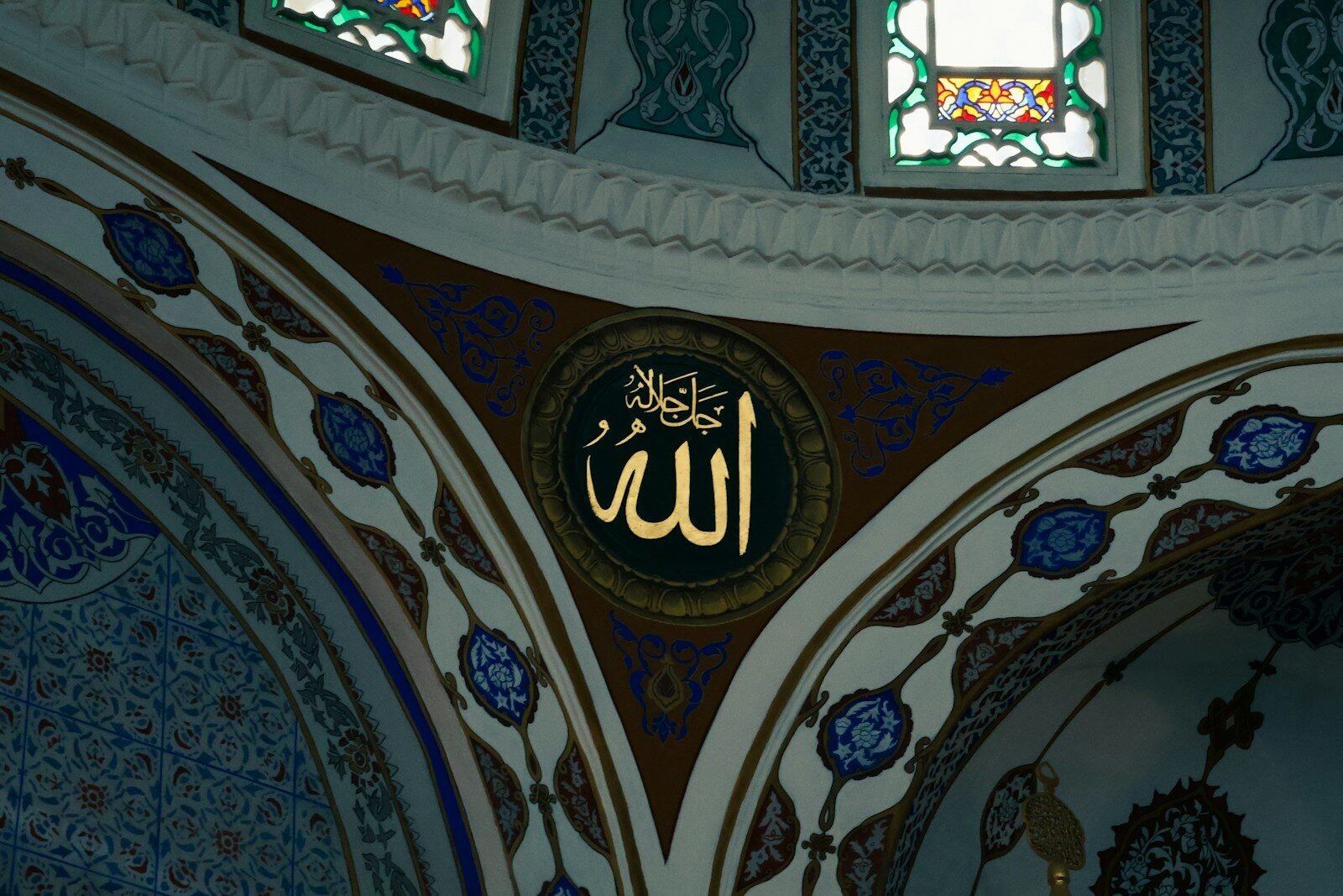 Golden arabic calligraphy on mosque dome interior